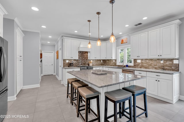 3 Algonquin Ct, Freehold, NJ 07728 - kitchen with a breakfast bar, tasteful backsplash, white cabinetry, a center island, and light tile patterned floors