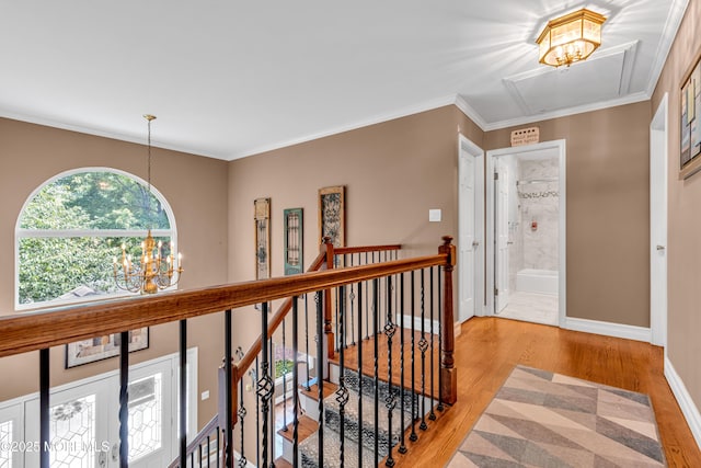 3 Algonquin Ct, Freehold, NJ 07728 - corridor featuring an upstairs landing, a chandelier, light wood-style floors, crown molding, and attic access