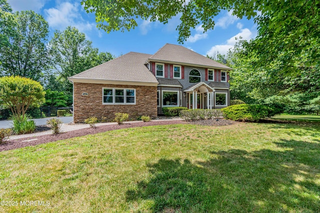 3 Algonquin Ct, Freehold, NJ 07728 - colonial home featuring a front yard, a shingled roof, and stone siding