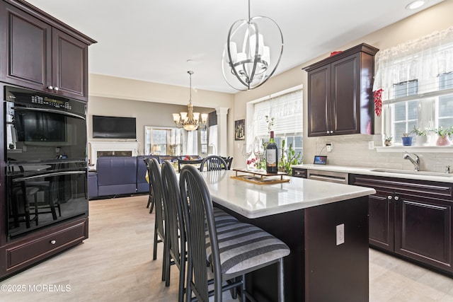 78 Honeysuckle Dr, Manahawkin, NJ 08050 - kitchen with a chandelier, decorative backsplash, pendant lighting, a breakfast bar area, and a center island