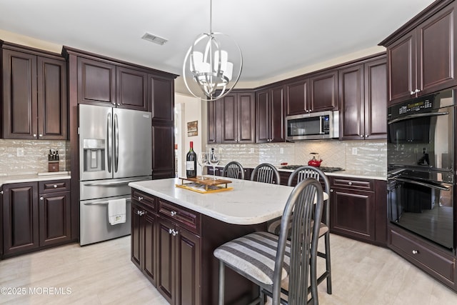 78 Honeysuckle Dr, Manahawkin, NJ 08050 - kitchen featuring stainless steel appliances, a kitchen breakfast bar, a chandelier, backsplash, and a kitchen island