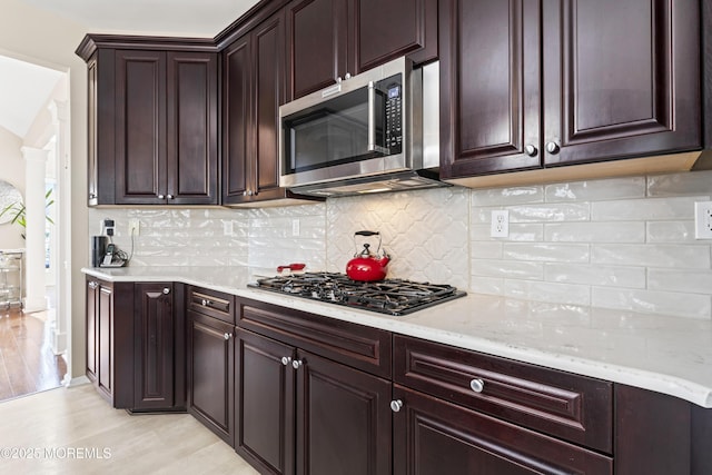 78 Honeysuckle Dr, Manahawkin, NJ 08050 - kitchen featuring stainless steel microwave, black gas cooktop, decorative columns, light wood finished floors, and dark brown cabinets