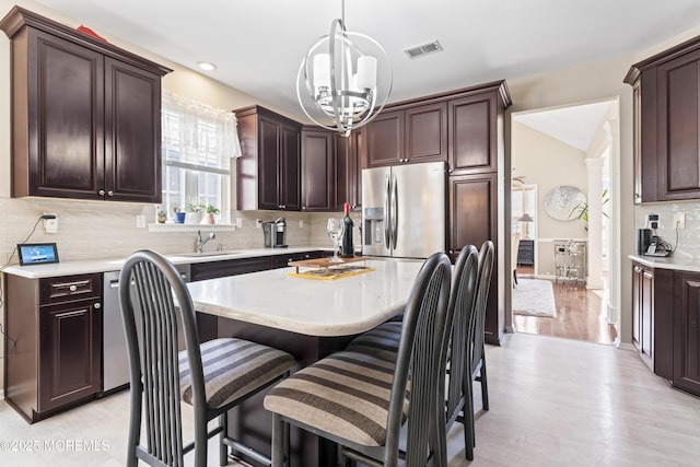 78 Honeysuckle Dr, Manahawkin, NJ 08050 - kitchen featuring stainless steel fridge with ice dispenser, light countertops, dark brown cabinetry, a chandelier, and tasteful backsplash