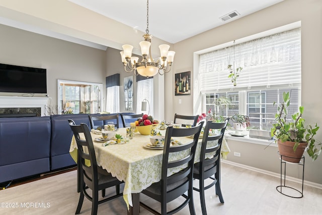 78 Honeysuckle Dr, Manahawkin, NJ 08050 - dining space featuring a chandelier, light wood-style flooring, and a fireplace