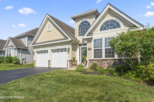 78 Honeysuckle Dr, Manahawkin, NJ 08050 - traditional-style house with driveway, a garage, stucco siding, a front yard, and stone siding