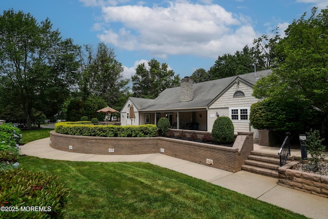 186 Snow Drop Pl, Freehold, NJ 07728 - view of front of house with a chimney and a front yard