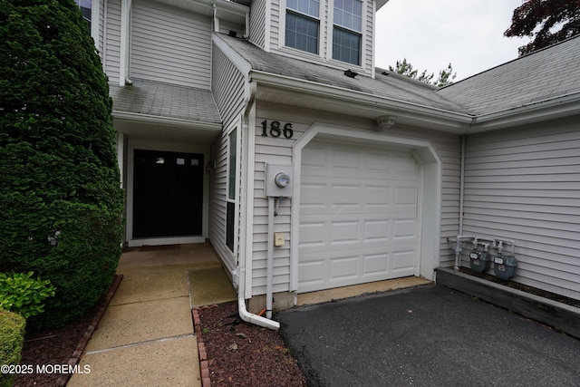 186 Snow Drop Pl, Freehold, NJ 07728 - property entrance with roof with shingles, driveway, and an attached garage