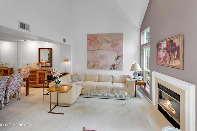 186 Snow Drop Pl, Freehold, NJ 07728 - living room featuring high vaulted ceiling, carpet floors, and a fireplace with flush hearth