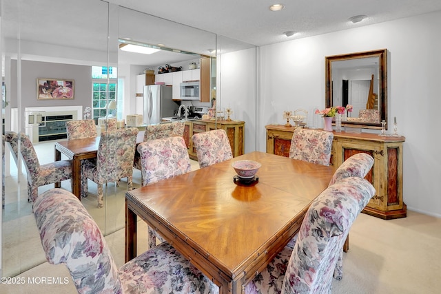 186 Snow Drop Pl, Freehold, NJ 07728 - dining area featuring a glass covered fireplace and recessed lighting