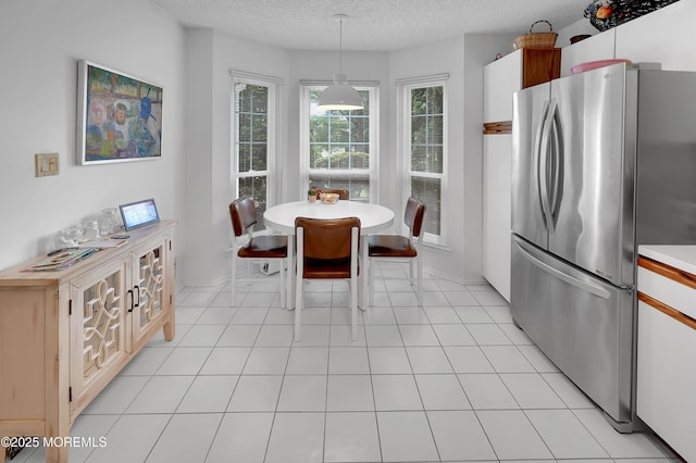 186 Snow Drop Pl, Freehold, NJ 07728 - dining space with a textured ceiling and baseboards