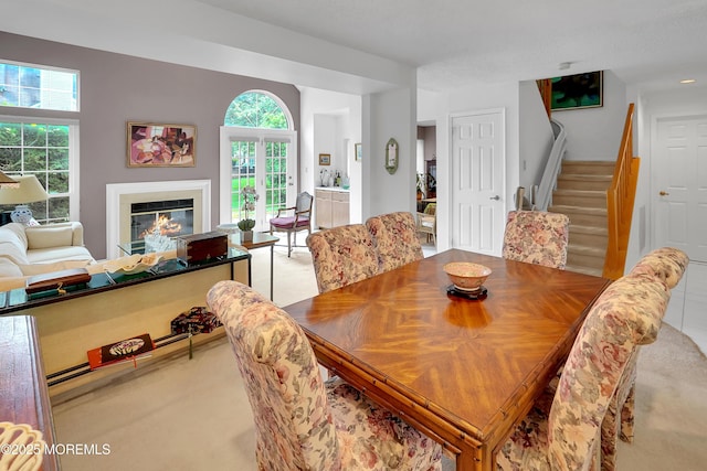 186 Snow Drop Pl, Freehold, NJ 07728 - dining room featuring stairs, a glass covered fireplace, and carpet flooring