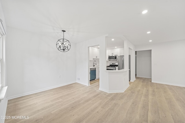 410 Owls Nest Ct, Jackson, NJ 08527 - unfurnished living room with recessed lighting, light wood finished floors, and a chandelier