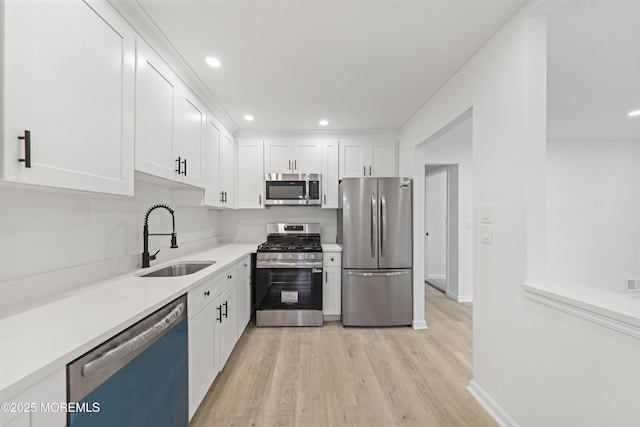410 Owls Nest Ct, Jackson, NJ 08527 - kitchen with stainless steel appliances, light wood-style flooring, white cabinetry, recessed lighting, and light countertops
