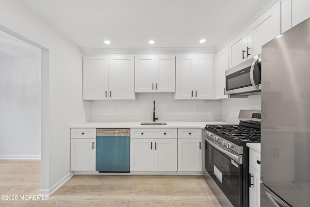 410 Owls Nest Ct, Jackson, NJ 08527 - kitchen with appliances with stainless steel finishes, light wood-style floors, white cabinets, light countertops, and recessed lighting