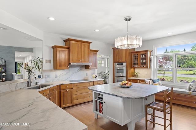 11 Sharon Dr, Ocean Twp, NJ 07712 - kitchen with stainless steel double oven, black electric cooktop, light stone counters, a kitchen bar, and recessed lighting