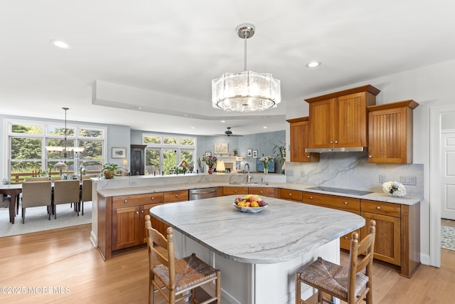 11 Sharon Dr, Ocean Twp, NJ 07712 - kitchen featuring a chandelier, a peninsula, brown cabinetry, black electric cooktop, and light wood finished floors