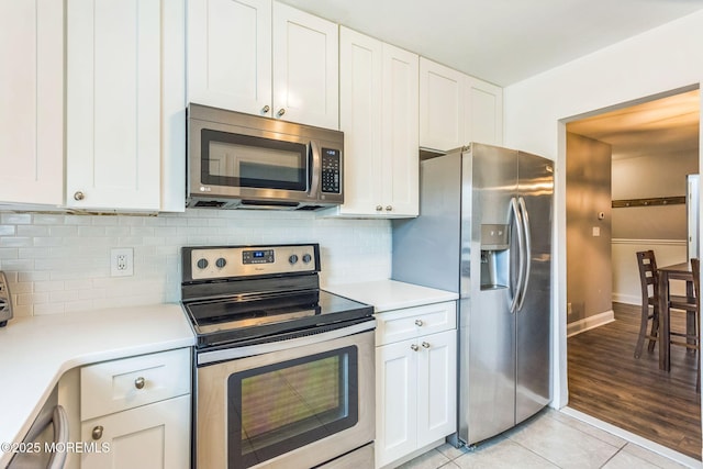 65 Cedar Ave Unit C10, Long Branch, NJ 07740 - kitchen with stainless steel appliances, light countertops, white cabinets, and backsplash