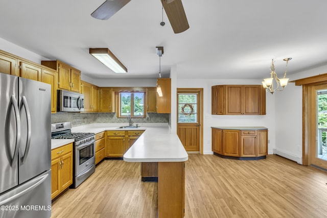 211 Meadow Blvd, Brick, NJ 08723 - kitchen with stainless steel appliances, a peninsula, plenty of natural light, and light countertops