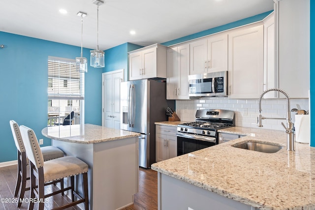 107 Celebration Blvd, Brick, NJ 08723 - kitchen featuring appliances with stainless steel finishes, dark wood finished floors, a kitchen island, tasteful backsplash, and recessed lighting