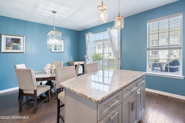 107 Celebration Blvd, Brick, NJ 08723 - kitchen featuring a chandelier, dark wood-style flooring, a kitchen bar, and light stone counters