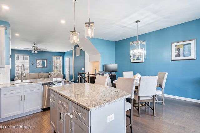 107 Celebration Blvd, Brick, NJ 08723 - kitchen with dishwasher, open floor plan, dark wood-type flooring, a breakfast bar, and light stone countertops