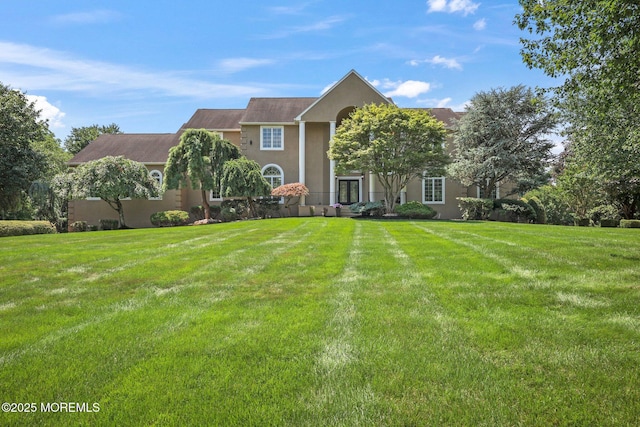 9 Old Cider Mill Rd, Manalapan, NJ 07726 - view of front facade featuring a front yard and stucco siding