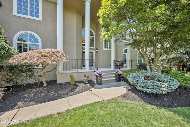 9 Old Cider Mill Rd, Manalapan, NJ 07726 - property entrance with stucco siding and a porch