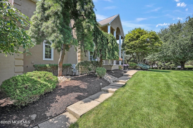 9 Old Cider Mill Rd, Manalapan, NJ 07726 - view of home's exterior with stucco siding and a yard