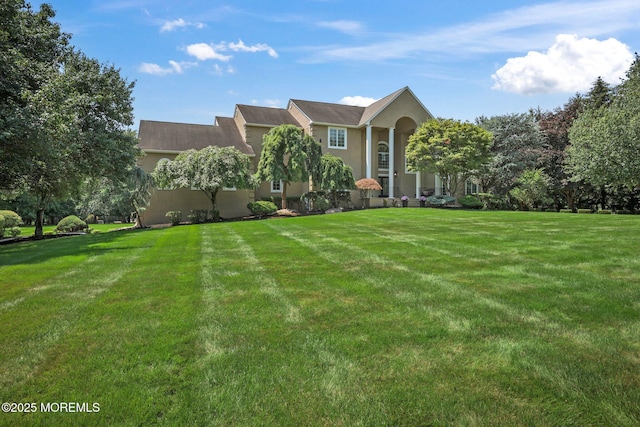 9 Old Cider Mill Rd, Manalapan, NJ 07726 - view of front facade featuring stucco siding and a front lawn