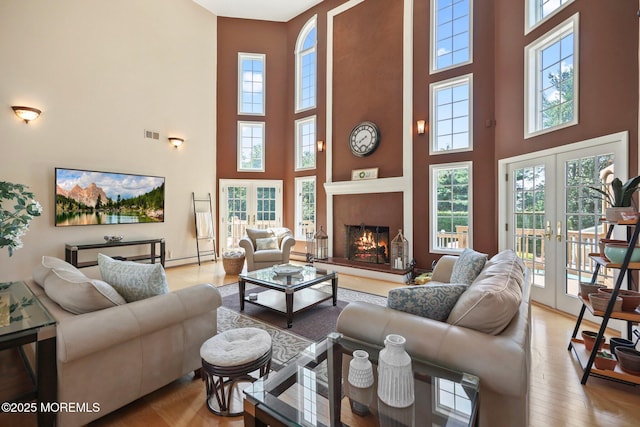 9 Old Cider Mill Rd, Manalapan, NJ 07726 - living area with a towering ceiling, plenty of natural light, french doors, and wood finished floors