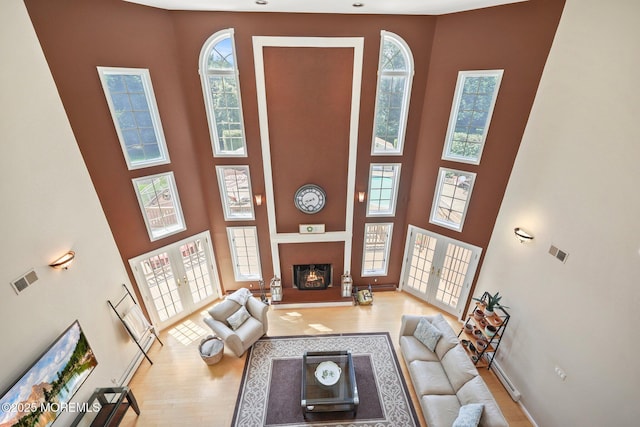 9 Old Cider Mill Rd, Manalapan, NJ 07726 - living area with a towering ceiling, wood finished floors, french doors, and a fireplace