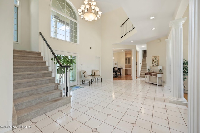 9 Old Cider Mill Rd, Manalapan, NJ 07726 - entryway with decorative columns, stairs, a high ceiling, and a chandelier