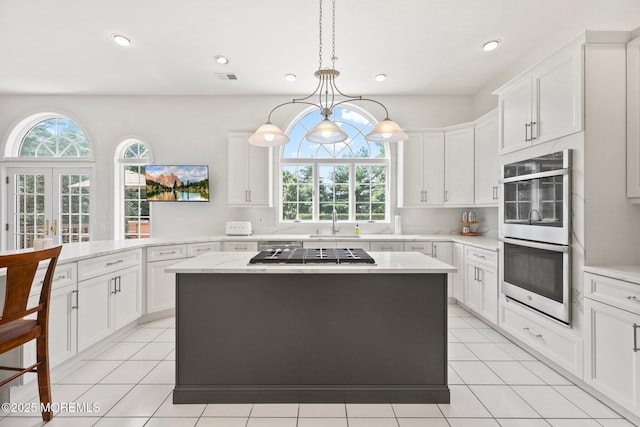 9 Old Cider Mill Rd, Manalapan, NJ 07726 - kitchen featuring appliances with stainless steel finishes, white cabinetry, a kitchen island, light tile patterned floors, and recessed lighting