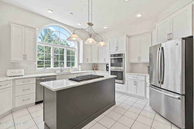 9 Old Cider Mill Rd, Manalapan, NJ 07726 - kitchen with stainless steel appliances, white cabinets, light tile patterned flooring, a center island, and recessed lighting