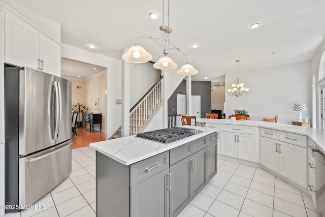 9 Old Cider Mill Rd, Manalapan, NJ 07726 - kitchen featuring stainless steel appliances, light tile patterned floors, gray cabinetry, a chandelier, and white cabinetry