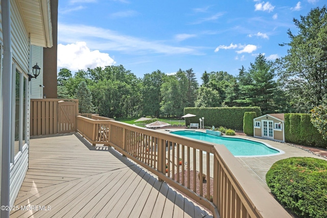 9 Old Cider Mill Rd, Manalapan, NJ 07726 - wooden deck with view of scattered trees, a patio area, and french doors
