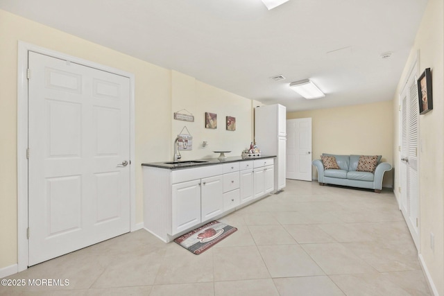 9 Old Cider Mill Rd, Manalapan, NJ 07726 - kitchen with dark countertops, light tile patterned floors, white cabinets, and open floor plan