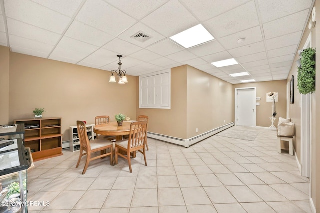 9 Old Cider Mill Rd, Manalapan, NJ 07726 - dining area featuring baseboard heating, a paneled ceiling, and a chandelier