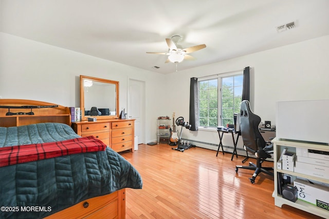 9 Old Cider Mill Rd, Manalapan, NJ 07726 - bedroom with wood finished floors, a baseboard heating unit, and a ceiling fan