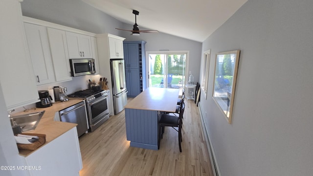 417 Carter Ave, Point Pleasant Beach, NJ 08742 - kitchen featuring vaulted ceiling, stainless steel appliances, ceiling fan, light wood-style flooring, and white cabinets