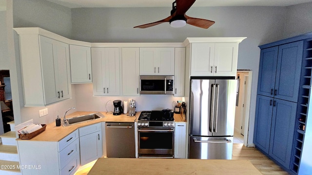 417 Carter Ave, Point Pleasant Beach, NJ 08742 - kitchen featuring stainless steel appliances, a ceiling fan, light countertops, blue cabinetry, and white cabinetry