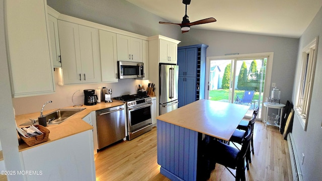 417 Carter Ave, Point Pleasant Beach, NJ 08742 - kitchen featuring stainless steel appliances, lofted ceiling, ceiling fan, light wood-type flooring, and a baseboard heating unit