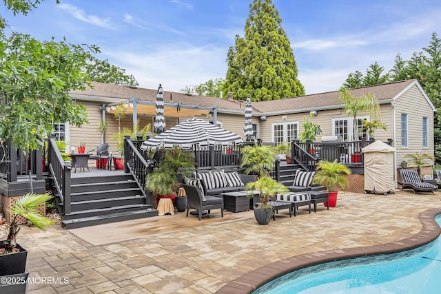 707 Cambridge Rd, Lanoka Harbor, NJ 08734 - rear view of house featuring a deck, a patio area, an outdoor pool, and an outdoor hangout area