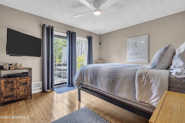 707 Cambridge Rd, Lanoka Harbor, NJ 08734 - bedroom with a textured ceiling, hardwood / wood-style floors, a ceiling fan, and access to exterior