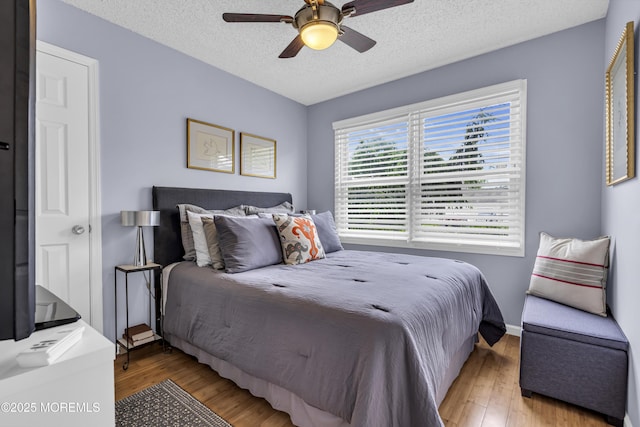 707 Cambridge Rd, Lanoka Harbor, NJ 08734 - bedroom with wood finished floors, a textured ceiling, and a ceiling fan