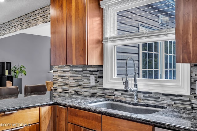 707 Cambridge Rd, Lanoka Harbor, NJ 08734 - kitchen with tasteful backsplash, dark stone counters, and brown cabinets