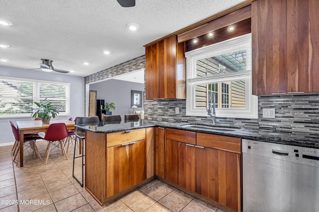 707 Cambridge Rd, Lanoka Harbor, NJ 08734 - kitchen featuring dishwasher, ceiling fan, brown cabinets, tasteful backsplash, and a textured ceiling