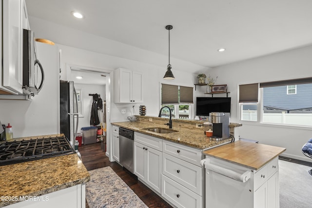 908 S Concourse, Keyport, NJ 07735 - kitchen with stainless steel appliances, white cabinets, recessed lighting, dark wood finished floors, and pendant lighting
