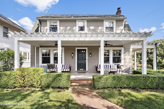 312 Lake Dr, Allenhurst, NJ 07711 - view of front of home featuring a ceiling fan, a porch, a chimney, and a pergola