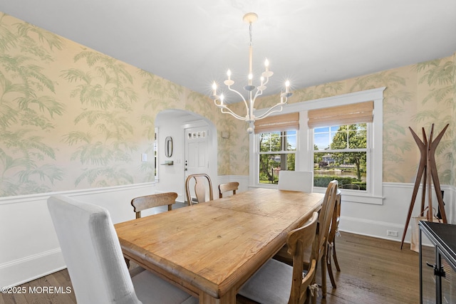 312 Lake Dr, Allenhurst, NJ 07711 - dining room with wallpapered walls, wainscoting, arched walkways, a chandelier, and dark wood-style flooring